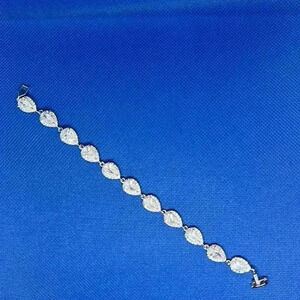 Pear shape cubic zirconia bracelet with halo mounting.